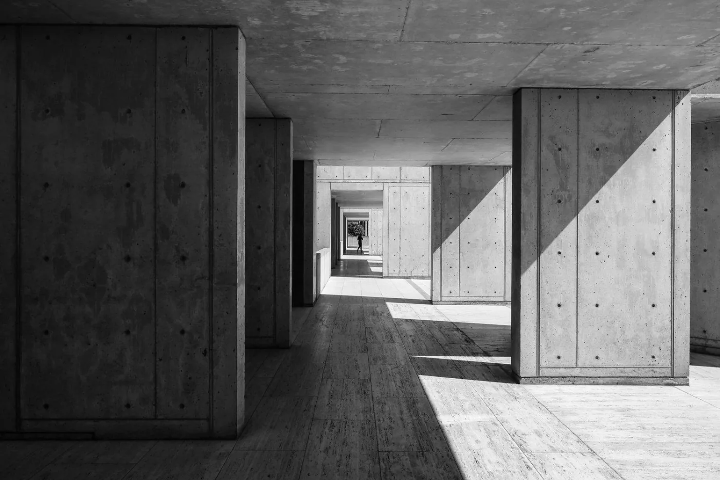 A concrete corridor organized by light and shadow.
